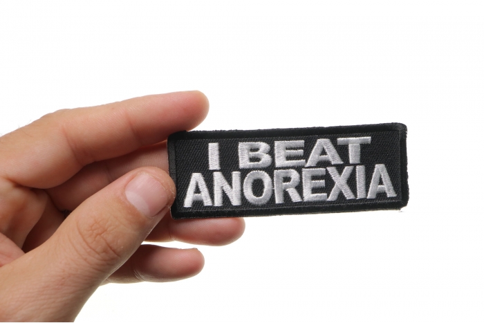 I Beat Anorexia Funny Iron on Patch shown on hand for size comparison