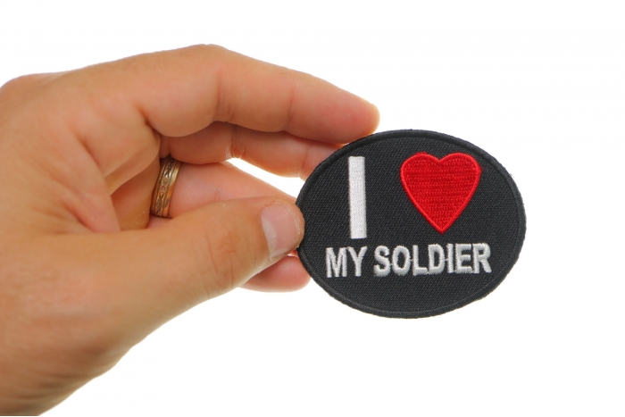I Love My Soldier Iron on Morale Patch shown on hand for size comparison