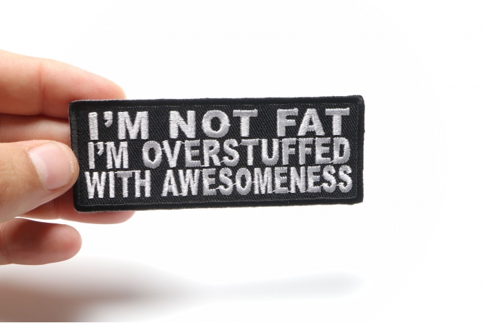 I'm Not Fat I'm Overstuffed With Awesomeness Iron on Morale Patch shown on hand for size comparison