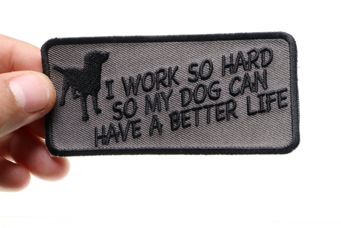 I Work So Hard So My Dog Can Have A Better Life Iron on Funny Patch shown on hand for size comparison