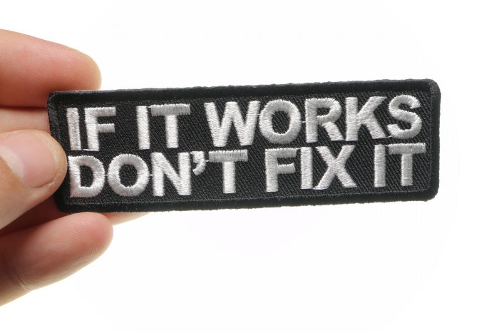 If It Works Don't Fix It Patch, Biker Sayings shown on hand for size comparison