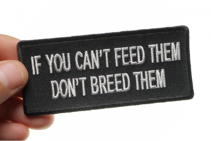 If You Can't Feed Them Don't Breed Them Iron on Morale Patch shown on hand for size comparison