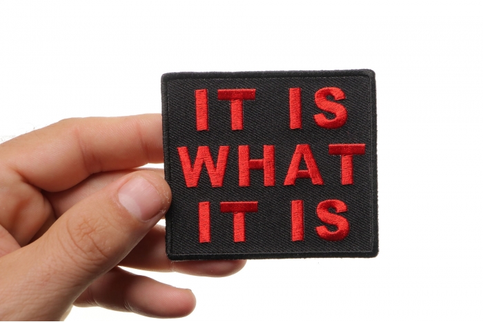 It Is What It Is Iron on Morale Patch In Red shown on hand for size comparison