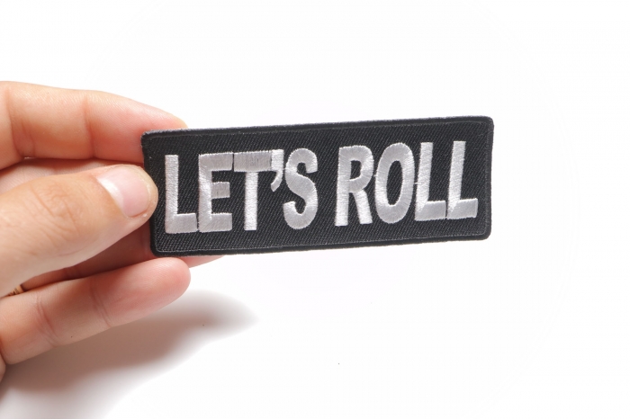 Let's Roll Iron on Fun Patch shown on hand for size comparison