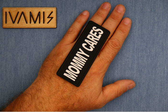 Mommy Cares Patch shown on hand for size comparison