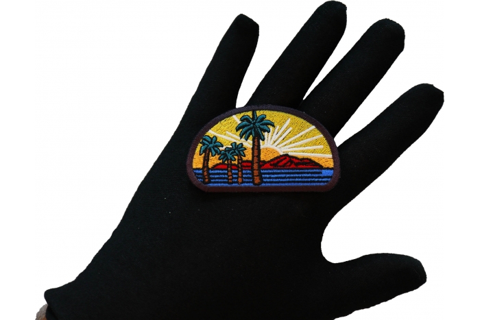 Palms and Sunset Iron on Patch shown on hand for size comparison