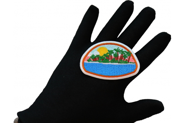 Paradise Island Iron on Patch shown on hand for size comparison