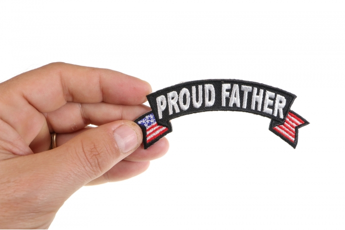 Proud Father US Flag Rocker Iron on Morale Patch shown on hand for size comparison