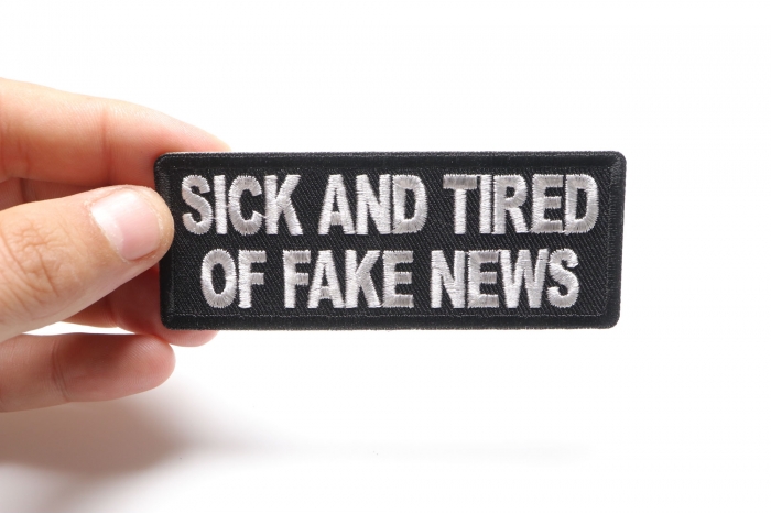 Sick And Tired Of Fake News Patch shown on hand for size comparison
