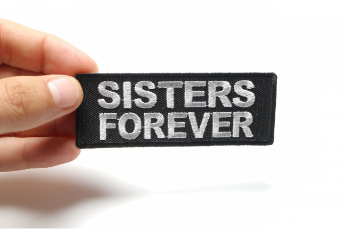 Sisters Forever Iron on Morale Patch shown on hand for size comparison