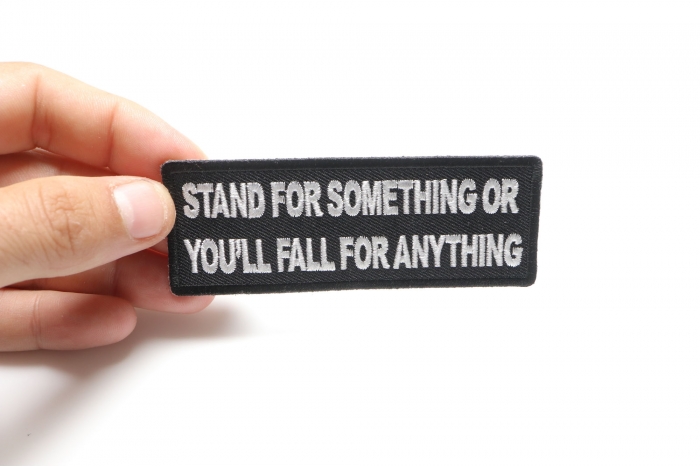 Stand For Something or You'll Fall For Anything Iron on Morale Patch shown on hand for size comparison