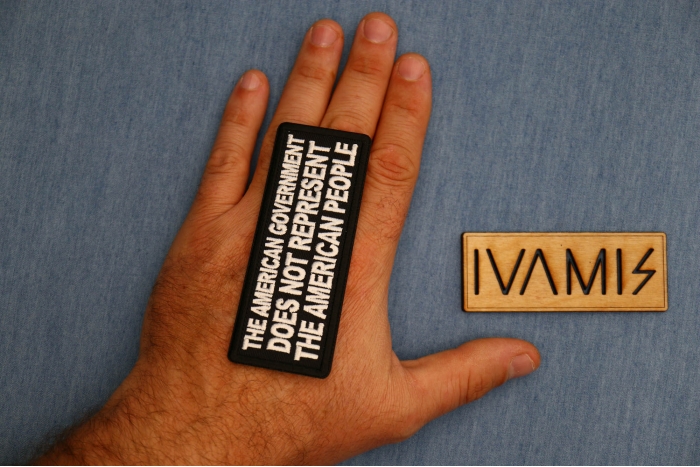 The American Government Does Not Represent The American People Patch shown on hand for size comparison