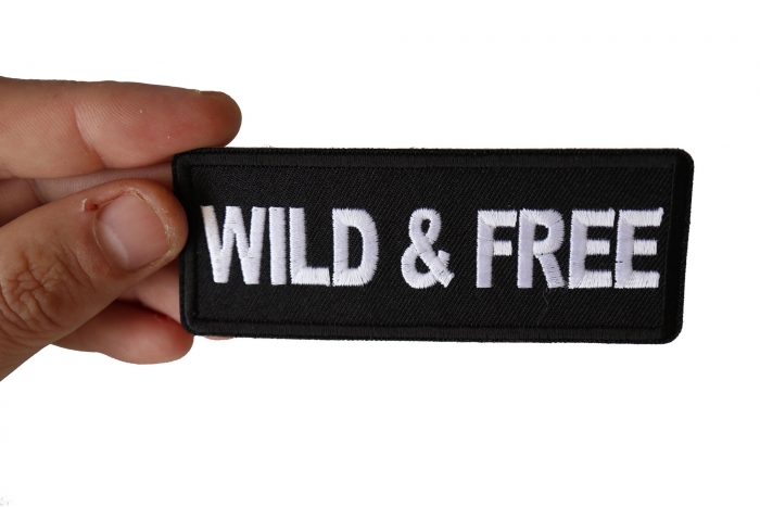 Wild and Free Iron on Morale Patch shown on hand for size comparison