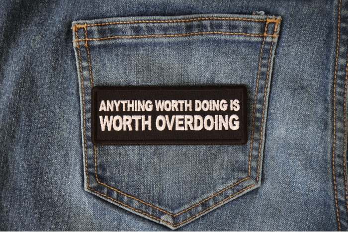 Anything Worth Doing is Worth Overdoing Patch shown on jeans