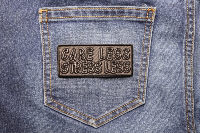 Care Less and Stress Less Patch shown on jeans