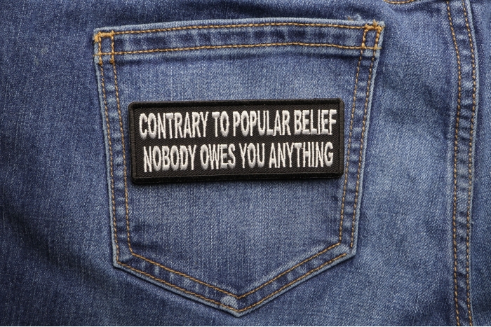 Contrary To Popular Belief Nobody Owes You Anything Iron on Morale Patch shown on jeans