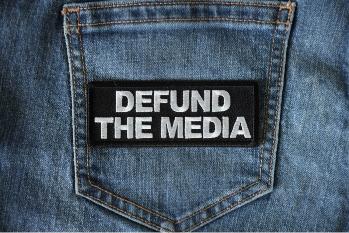 Defund the Media Patch shown on jeans