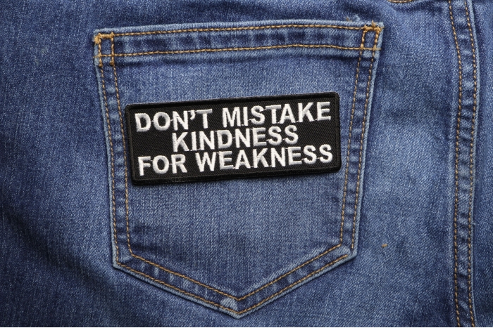 Don't Mistake Kindness For Weakness Patch shown on jeans