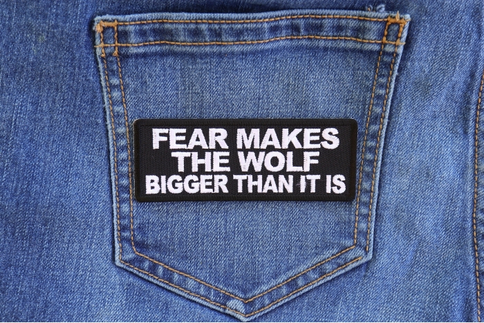 Fear Makes The Wolf Bigger Than it is Iron on Morale Patch shown on jeans