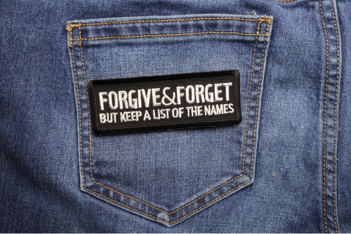 Forgive and Forget But Keep A List Of The Names Iron on Morale Patch shown on jeans