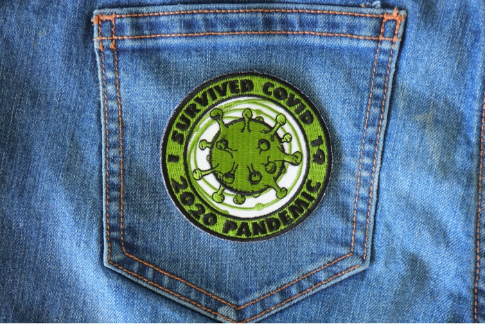 I survived covid 19 Iron on Corona Virus Patch shown on jeans