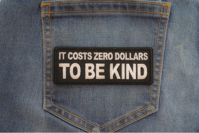 It costs zero dollars to be kind patch shown on jeans