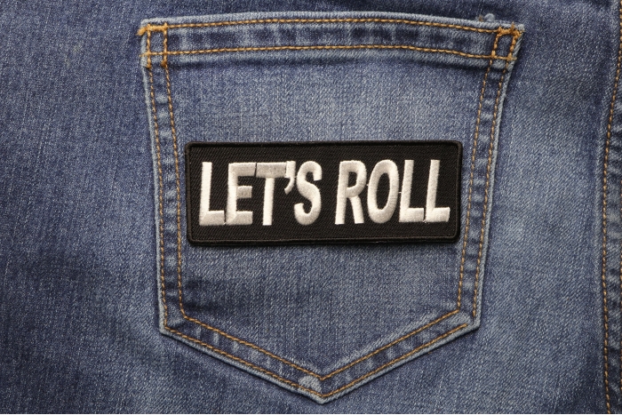 Let's Roll Iron on Fun Patch shown on jeans