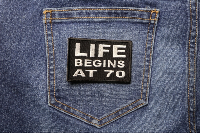 Life Begins at 70 Iron on Morale Patch shown on jeans