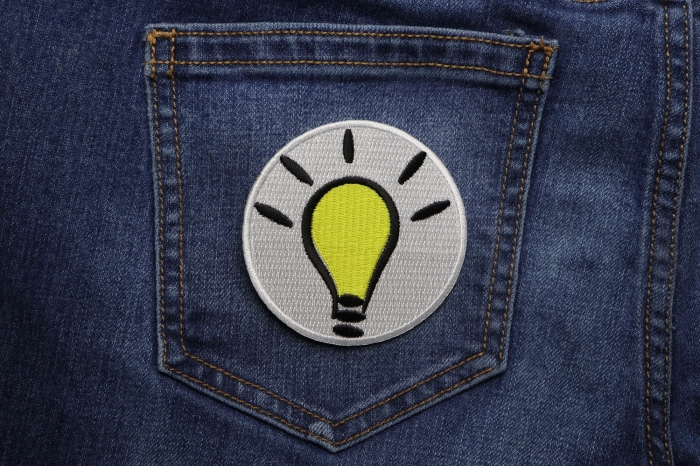 Light Bulb Idea Iron on Iron on Morale Patch shown on jeans