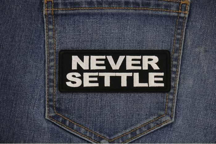 Never Settle Patch shown on jeans
