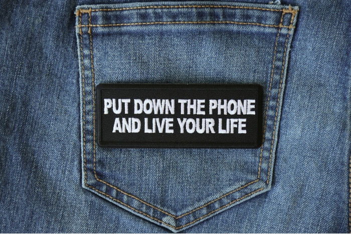 Put Down the Phone and Live Your Life Iron on Morale Patch shown on jeans