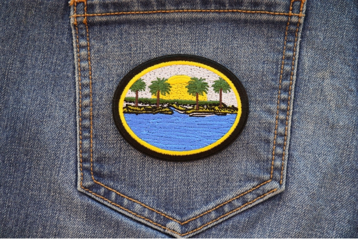 Sea and Palms Sunset Iron on Patch shown on jeans