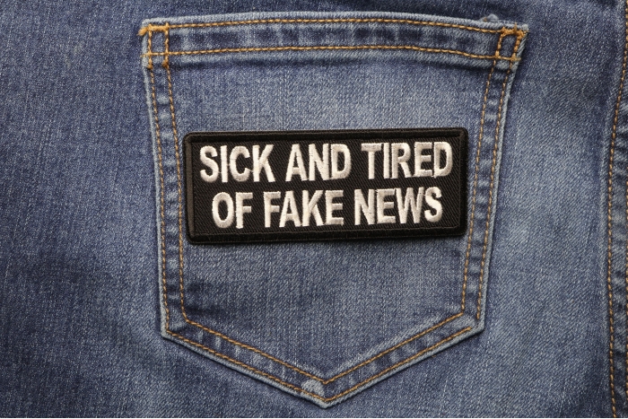 Sick And Tired Of Fake News Patch shown on jeans