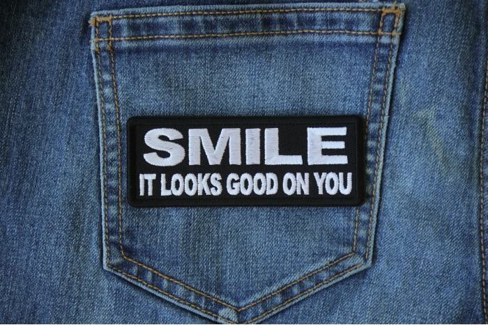 Smile It Looks Good on You Iron on Morale Patch shown on jeans