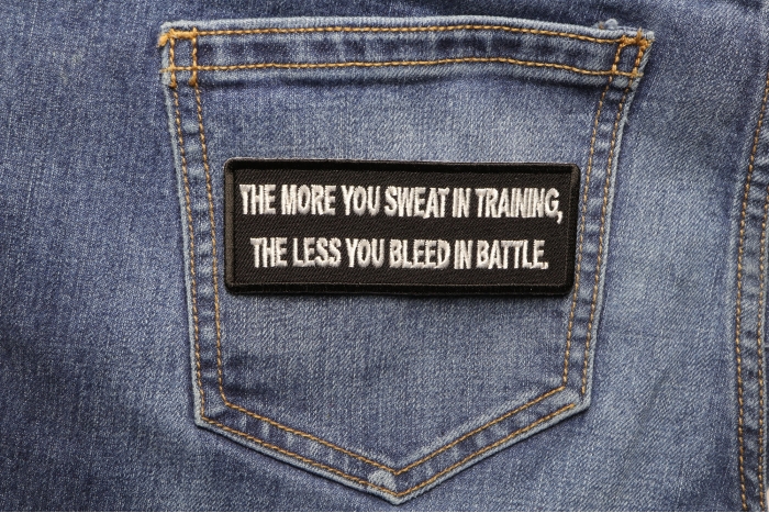 The More You Sweat In Training, The Less You Bleed in  Battle Patch shown on jeans