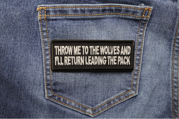 Throw Me to the Wolves and I'll Return Leading the Pack Iron on Morale Patch shown on jeans