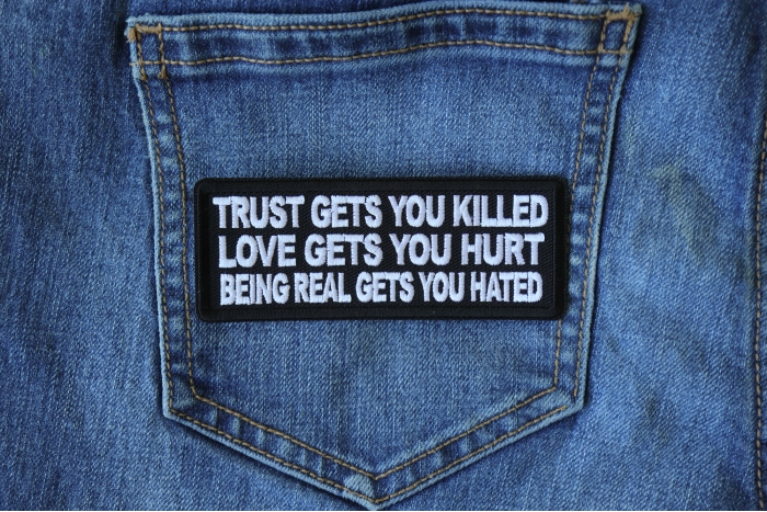 Trust Gets You Killed Love Gets you Hurt Being Real gets you Hated Patch shown on jeans