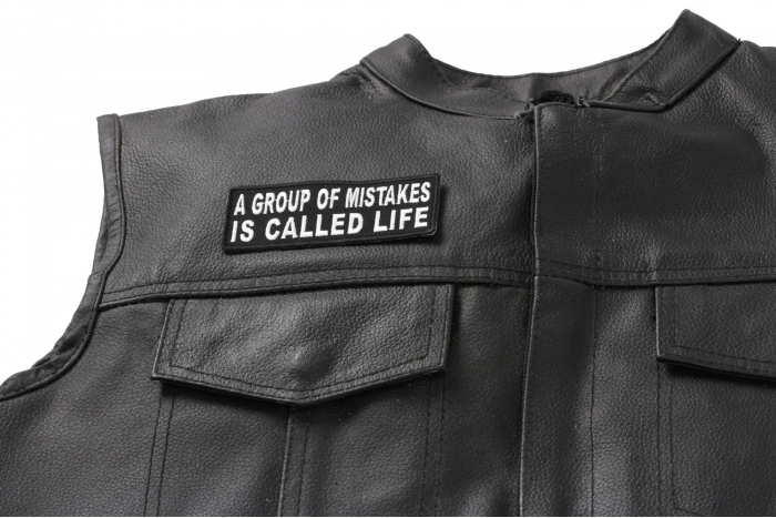 A Group Of Mistakes Is Called Life Patch - 4x1.5 inch. Embroidered Iron on Patch shown on leather vest