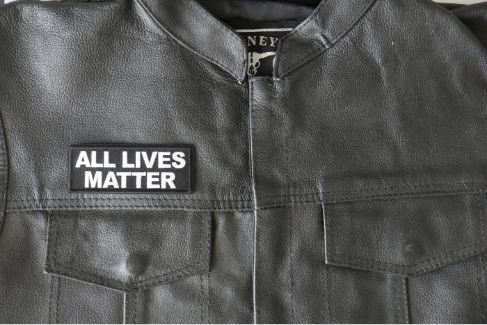 All Lives Matter Patch - 4x1.5 inch - Embroidered Iron on Patch shown on leather vest