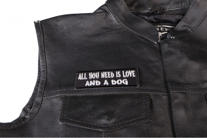 All You Need is Love and a Dog Patch - 4x1.5 inch. Embroidered Iron on Patch shown on leather vest