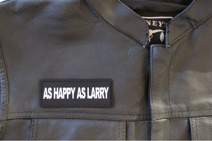 As Happy As Larry Patch - 4x1.5 inch - Embroidered Iron on Patch shown on leather vest