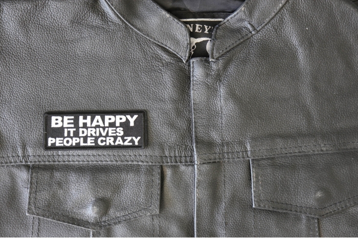 Be Happy it Drives People Crazy Patch - 4x1.5 inch - Embroidered Iron on Patch shown on leather vest