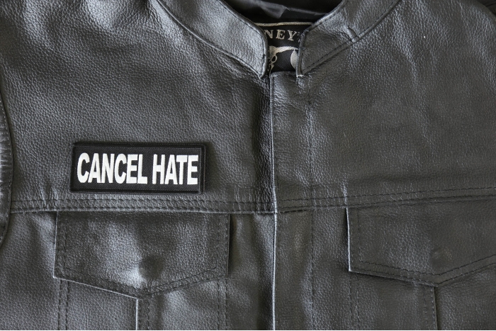 Cancel Hate Patch - 4x1.5 inch - Embroidered Iron on Patch shown on leather vest