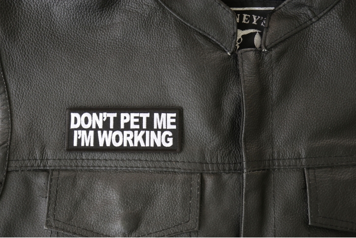 Don't Pet Me I'm Working Patch - 4x1.5 inch - Embroidered Iron on Patch shown on leather vest