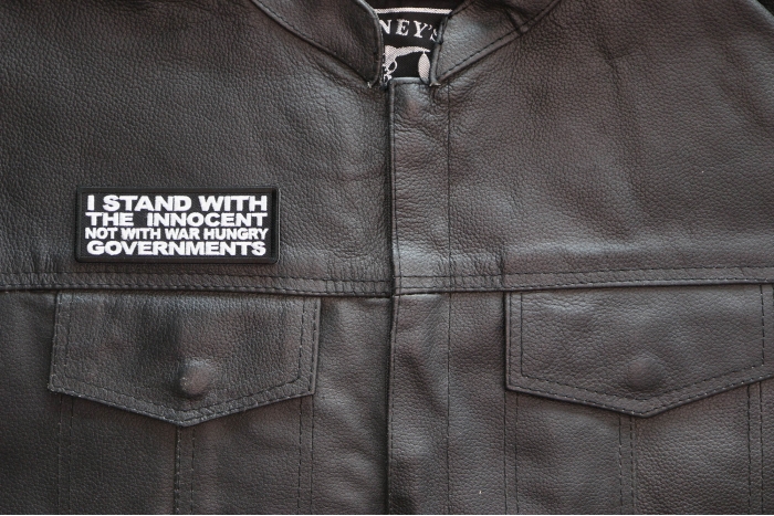 I Stand with the innocent Not with a war hungry Governments Patch shown on leather vest