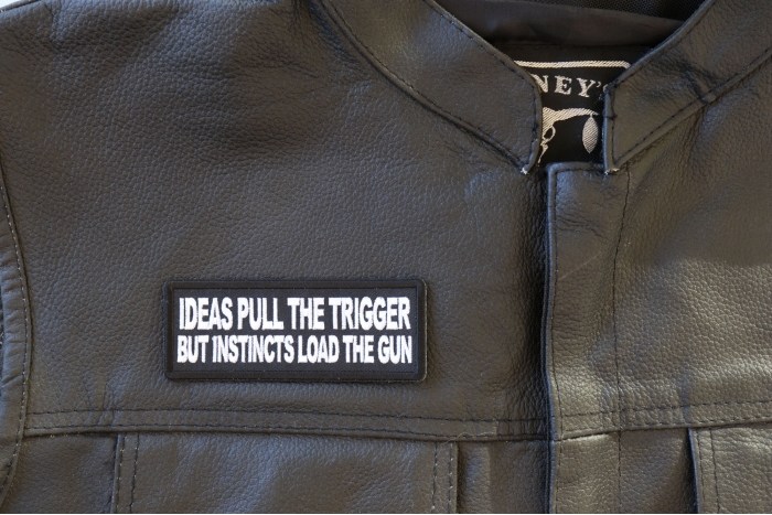 Ideas Pull the Trigger But Instincts Load the Gun Patch - 4x1.5 inch - Embroidered Iron on Patch shown on leather vest