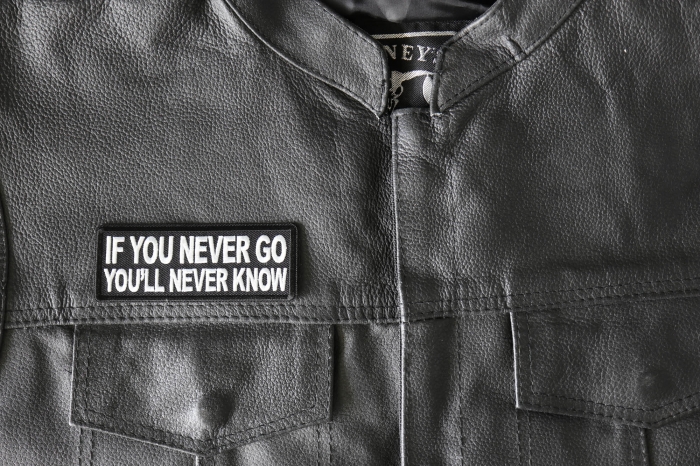 If you never go You'll Never Know Patch - 4x1.5 inch - Embroidered Iron on Patch shown on leather vest