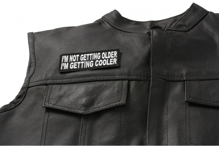 I'm Not Getting Older I'm Getting Cooler Fun Patch - 4x1.5 inch. Embroidered Iron on Patch shown on leather vest