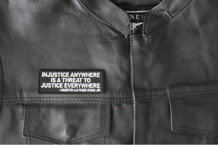 Injustice anywhere is a threat to Justice Everywhere MLK Jr Patch - 4x1.5 inch - Embroidered Iron on Patch shown on leather vest