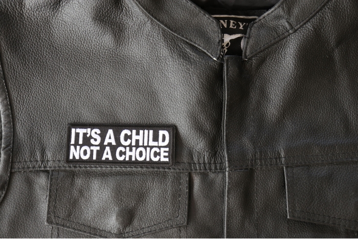 IT's a Child not a Choice Patch - 4x1.5 inch - Embroidered Iron on Patch shown on leather vest
